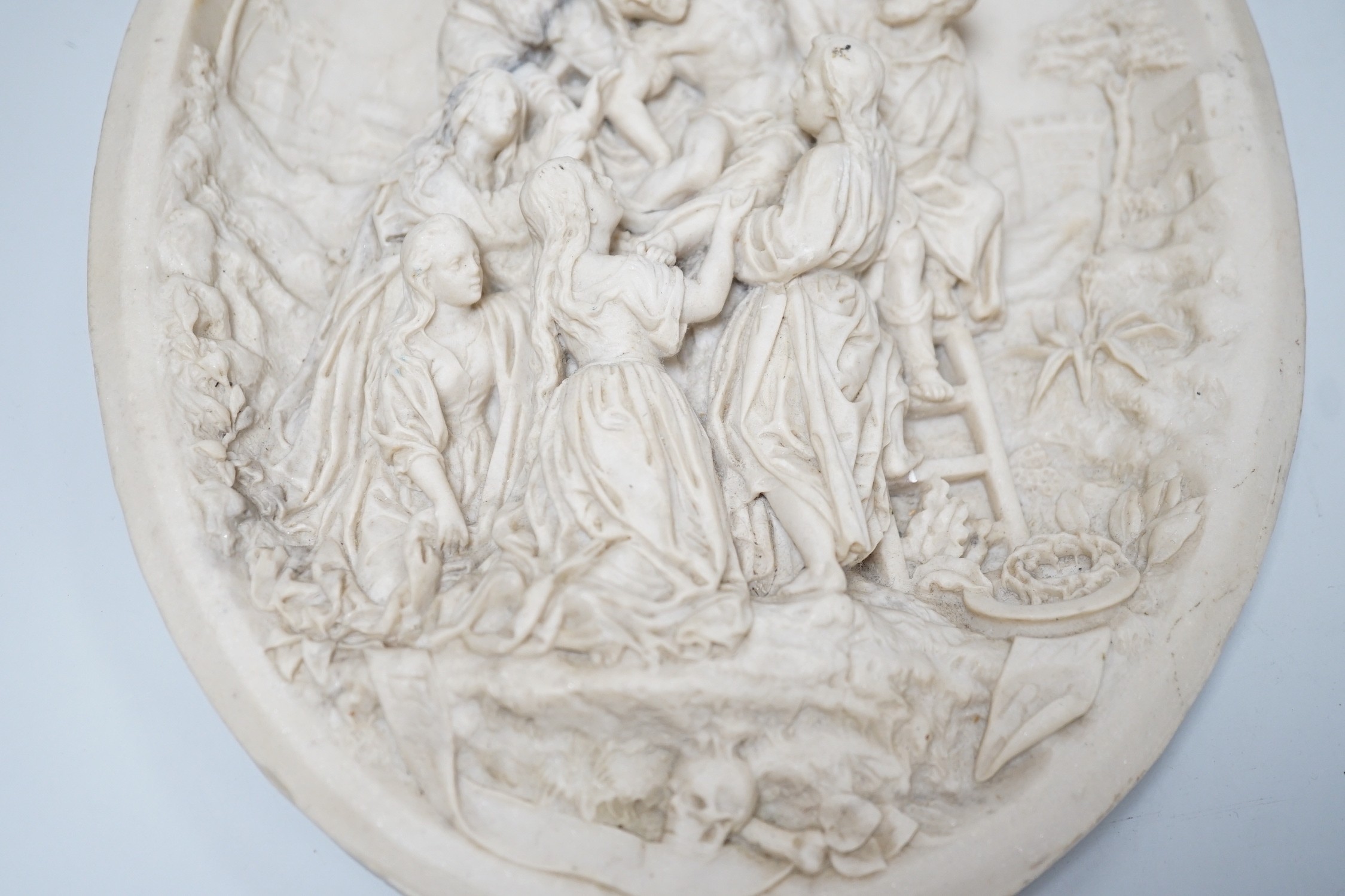A reproduction reconstituted marble oval plaque with inset coin to reverse, 30cm